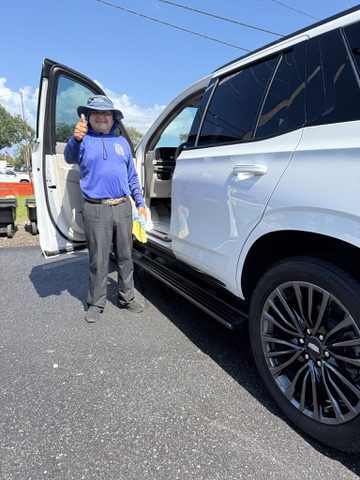 An SUV being detailed, photographed upright from the side of the vehicle.